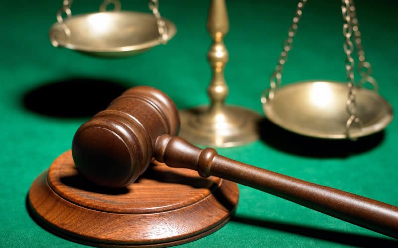 Judge’s gavel and brass scales of justice on a green table, illustrating a Spanish court ruling on Club La Costa contract nullity