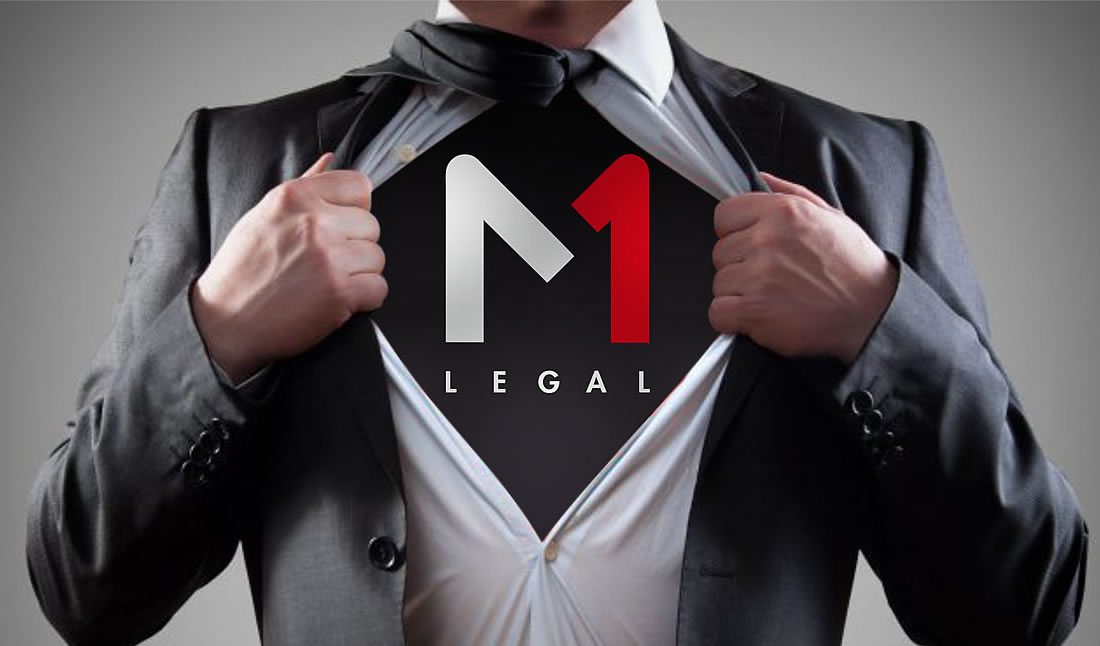 Person in a suit pulling open their shirt to reveal the M1 Legal logo underneath, superhero-style