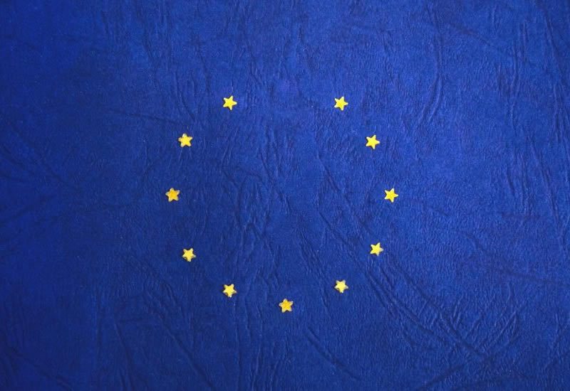 European Union flag with yellow stars on a blue background, used to illustrate cross border mediation after Brexit