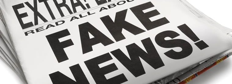 Close-up of a newspaper with the headline “FAKE NEWS!” in bold black letters and “EXTRA! EXTRA! READ ALL ABOUT” above it