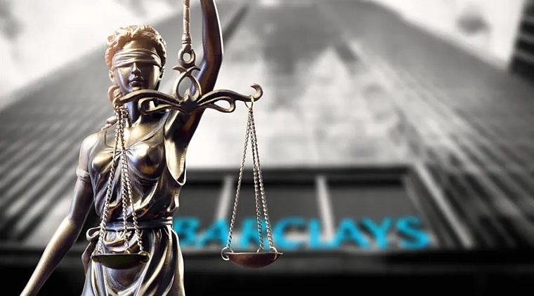Blindfolded Lady Justice statue holding scales in front of a blurred Barclays bank sign