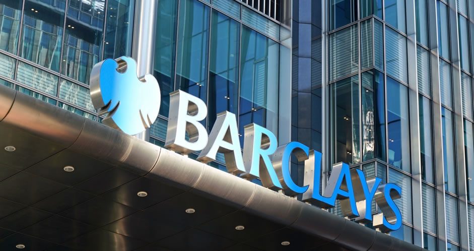 Barclays logo and signage on the exterior of a modern glass office building.
