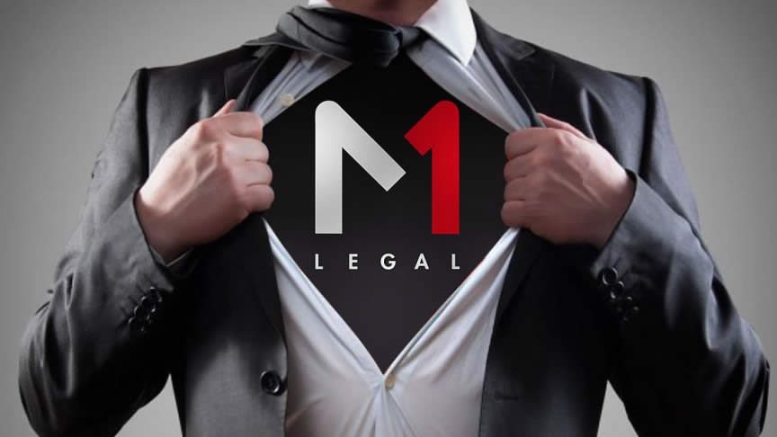 Businessman in a suit pulling open his shirt to reveal an “M1 Legal” logo underneath