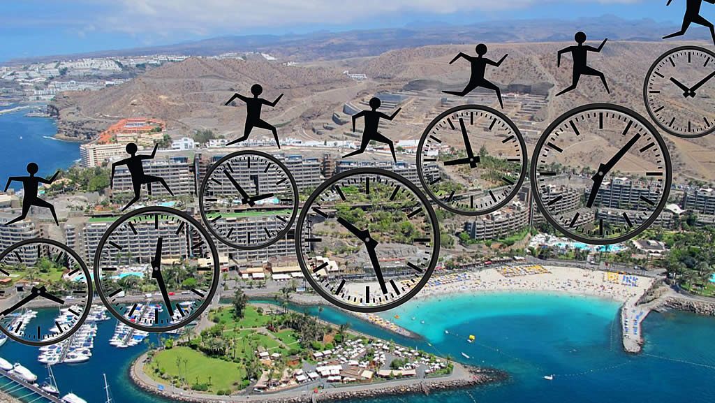 Aerial view of a seaside resort and marina with overlaid clocks and silhouetted figures jumping between them, suggesting a deadline approaching