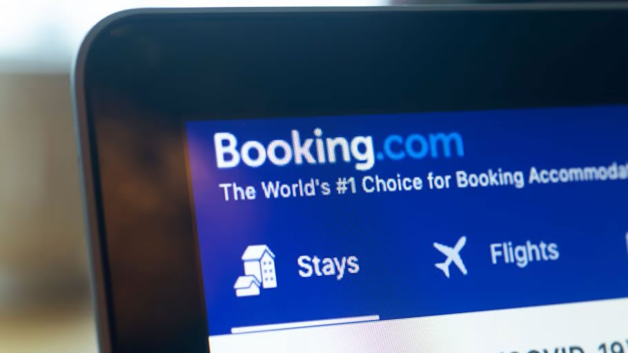 Close-up of a laptop screen showing the Booking.com homepage navigation with “Stays” and “Flights” options