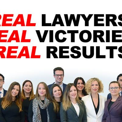 Group of solicitors in business attire standing beneath the headline “Real lawyers, real victories, real results”