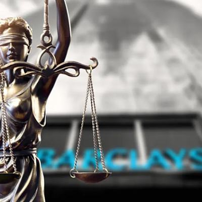 Blindfolded Lady Justice statue holding scales in front of a blurred Barclays bank sign