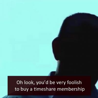 Silhouette of a man against a blue background with on-screen subtitle about buying a timeshare membership and ECC logo in the corner