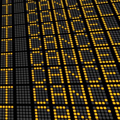 Airport departures board showing rows of cancelled flights in amber dot-matrix text