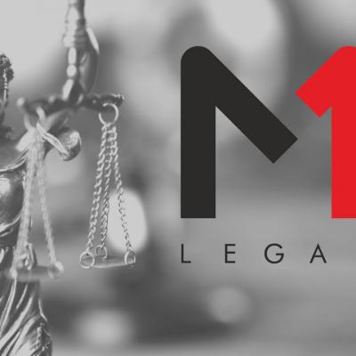 Lady Justice statue holding scales beside the M1 Legal logo on a blurred grey background
