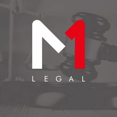 M1 Legal logo over blurred photo of a judge’s gavel and scales of justice
